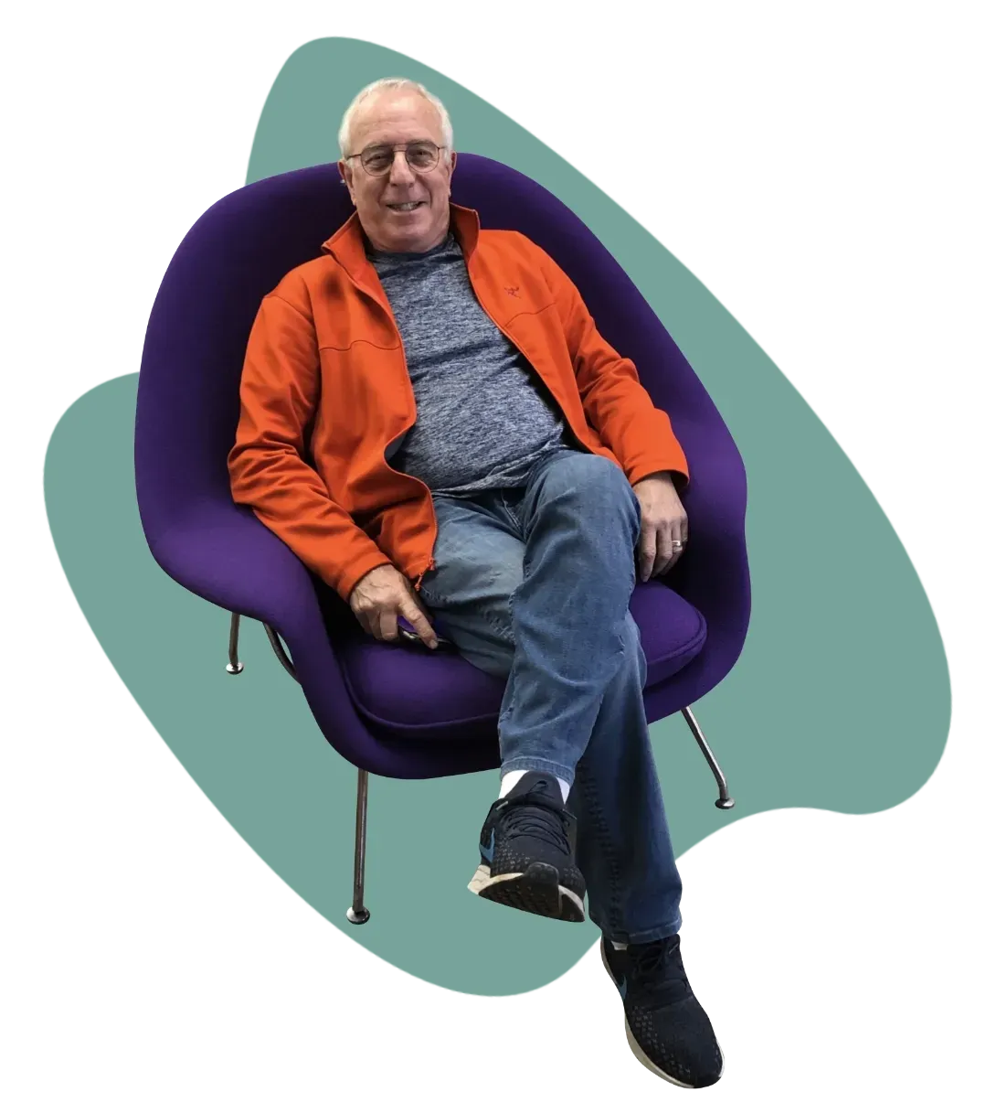 Happy older man seated in his newly restored purple fabric covered Knoll Studio Womb Lounge Chair